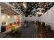 Backyard patio with a hot tub, outdoor seating, string lights, and a privacy fence at 3521 Almeria Ave, Sarasota, FL 34239