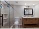 Modern bathroom featuring a double sink vanity and a tiled shower with glass door at 3521 Almeria Ave, Sarasota, FL 34239