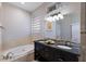 Bathroom features a soaking tub and double sink vanity with granite countertop at 3521 Almeria Ave, Sarasota, FL 34239