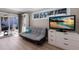 Bedroom featuring a futon, TV, and sliding glass doors to the outdoor area at 3521 Almeria Ave, Sarasota, FL 34239