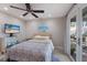 Cozy bedroom featuring a ceiling fan, TV, and access to an outdoor patio at 3521 Almeria Ave, Sarasota, FL 34239