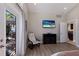 Bedroom features wood floors, beach themed television and easy access to the kitchen at 3521 Almeria Ave, Sarasota, FL 34239