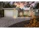 Charming home featuring pea gravel drive, lush landscaping, and detached garage at 3521 Almeria Ave, Sarasota, FL 34239