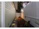Side yard with stone walkway and lush landscaping next to the light green siding at 3521 Almeria Ave, Sarasota, FL 34239