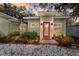 Inviting home featuring a bright red front door, manicured landscaping, and a pergola at 3521 Almeria Ave, Sarasota, FL 34239