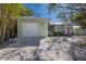 Charming home featuring a gravel driveway and a well-manicured front yard with mature trees at 3521 Almeria Ave, Sarasota, FL 34239