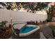 Backyard hot tub surrounded by tropical plants and tiki torches for a relaxing atmosphere at 3521 Almeria Ave, Sarasota, FL 34239