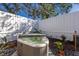 A cozy hot tub surrounded by tropical plants in a private, fenced-in backyard at 3521 Almeria Ave, Sarasota, FL 34239