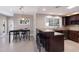 Well-lit kitchen featuring sleek, dark cabinetry, granite countertops, and stainless steel appliances at 3521 Almeria Ave, Sarasota, FL 34239