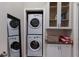 Convenient laundry room with stacked washer and dryer and storage cabinets at 3521 Almeria Ave, Sarasota, FL 34239