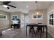 Open-concept living and dining area with tile floors and modern decor at 3521 Almeria Ave, Sarasota, FL 34239