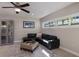 Comfortable living room featuring a large black leather sectional and display cabinet at 3521 Almeria Ave, Sarasota, FL 34239