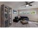 Comfortable living room featuring a large black leather sectional and display cabinet at 3521 Almeria Ave, Sarasota, FL 34239