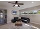 Comfortable living room featuring a large black leather sectional and display cabinet at 3521 Almeria Ave, Sarasota, FL 34239