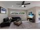 Comfortable living room featuring a large black leather sectional and a flat screen TV at 3521 Almeria Ave, Sarasota, FL 34239
