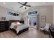 Spacious main bedroom with a fan, high ceilings, and french doors to an outdoor patio space at 3521 Almeria Ave, Sarasota, FL 34239