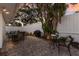 Private backyard patio with pavers, outdoor dining, a grill, and tropical landscaping with string lights at 3521 Almeria Ave, Sarasota, FL 34239