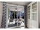 Covered patio with rocking chairs, tiled flooring, and access to backyard at 3521 Almeria Ave, Sarasota, FL 34239