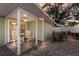 Charming covered patio with rocking chairs, ceiling fan, and outdoor lighting near a dining area at 3521 Almeria Ave, Sarasota, FL 34239