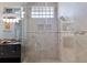 Glass enclosed shower featuring tile surround, mosaic accents, and overhead shower head at 3521 Almeria Ave, Sarasota, FL 34239
