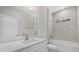 Bright bathroom featuring a bathtub, tiled walls, and a modern vanity with light countertop and a rectangular mirror at 36 Gilbert St, North Port, FL 34288