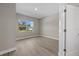 Empty bedroom featuring modern wood-look floors and a window with a neighborhood view at 36 Gilbert St, North Port, FL 34288