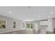 Bright living room featuring wood-look floors, recessed lighting, and sliding glass doors to the backyard at 36 Gilbert St, North Port, FL 34288