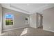 Spacious main bedroom with wood-look floors, recessed lighting, and two windows at 36 Gilbert St, North Port, FL 34288