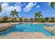 Community pool with palm trees and plenty of space for swimming and sunbathing at 3645 Tin Cup Blvd, Sarasota, FL 34232
