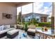 Relaxing screened-in porch with comfortable seating, dart board, and view of landscaped backyard at 3645 Tin Cup Blvd, Sarasota, FL 34232