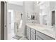 Bright bathroom featuring double sinks, marble countertops, and a glass enclosed shower at 3711 Manorwood Loop, Parrish, FL 34219