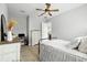 A simple bedroom with a desk, dresser, and views into an adjacent living space at 3711 Manorwood Loop, Parrish, FL 34219