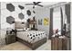 Trendy bedroom featuring a bed with soccer ball accents and a statement wall at 3711 Manorwood Loop, Parrish, FL 34219