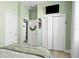 Neutral bedroom featuring a bed, double closet doors, and ensuite bathroom at 3711 Manorwood Loop, Parrish, FL 34219