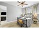 Comfortable bedroom featuring a wrought iron bed, a ceiling fan and a calming neutral color palette at 3711 Manorwood Loop, Parrish, FL 34219