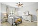 Cozy bedroom with neutral decor, a ceiling fan, and ample natural light from the window at 3711 Manorwood Loop, Parrish, FL 34219