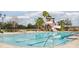 A large community pool with palm trees, lounge chairs, and a slide creating a relaxing environment at 3711 Manorwood Loop, Parrish, FL 34219