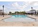 A large community pool with palm trees, lounge chairs, and a slide creating a relaxing environment at 3711 Manorwood Loop, Parrish, FL 34219