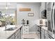 Close-up of the kitchen area with stainless steel appliances and a farmhouse-style decor, with a view to an outside patio at 3711 Manorwood Loop, Parrish, FL 34219