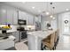Modern kitchen featuring stainless steel appliances, granite countertops, and bar stool seating at 3711 Manorwood Loop, Parrish, FL 34219