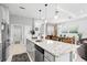 Spacious kitchen with granite countertops and stainless steel appliances, flowing into the dining and living areas at 3711 Manorwood Loop, Parrish, FL 34219