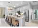 Modern kitchen featuring stainless steel appliances, granite countertops, and bar stool seating at 3711 Manorwood Loop, Parrish, FL 34219