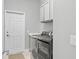 Convenient laundry room with washer, dryer, utility sink and ample storage at 3711 Manorwood Loop, Parrish, FL 34219