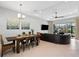 Open-concept living and dining area featuring tile flooring and abundant natural light at 3711 Manorwood Loop, Parrish, FL 34219