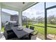 Screened-in patio with outdoor dining table and backyard view, perfect for entertaining at 3711 Manorwood Loop, Parrish, FL 34219