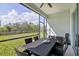 Outdoor screened-in patio with dining set and ceiling fan for comfortable entertaining at 3711 Manorwood Loop, Parrish, FL 34219