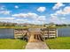Community pond with wooden pier and access, surrounded by well-maintained grass and homes at 3711 Manorwood Loop, Parrish, FL 34219