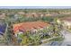 Aerial view of a multi-unit building with a terracotta roof and mature trees at 3760 82Nd Avenue E Cir # 101, Sarasota, FL 34243