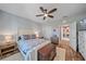 Bright bedroom features wood floors, a ceiling fan, and a large decorative chest at 3760 82Nd Avenue E Cir # 101, Sarasota, FL 34243