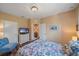 Bedroom with a television, a floral comforter, and a comfortable blue chair at 3760 82Nd Avenue E Cir # 101, Sarasota, FL 34243